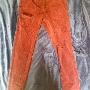 Maroon corduroy pants.